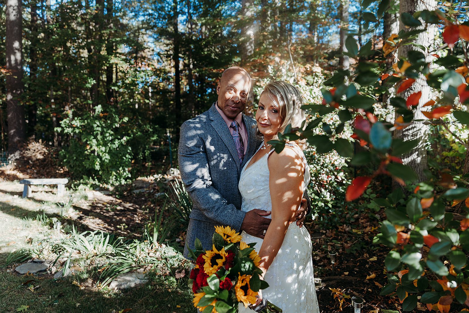 Newlyweds smile while hugging in the gardens of the Saratoga Winery wedding