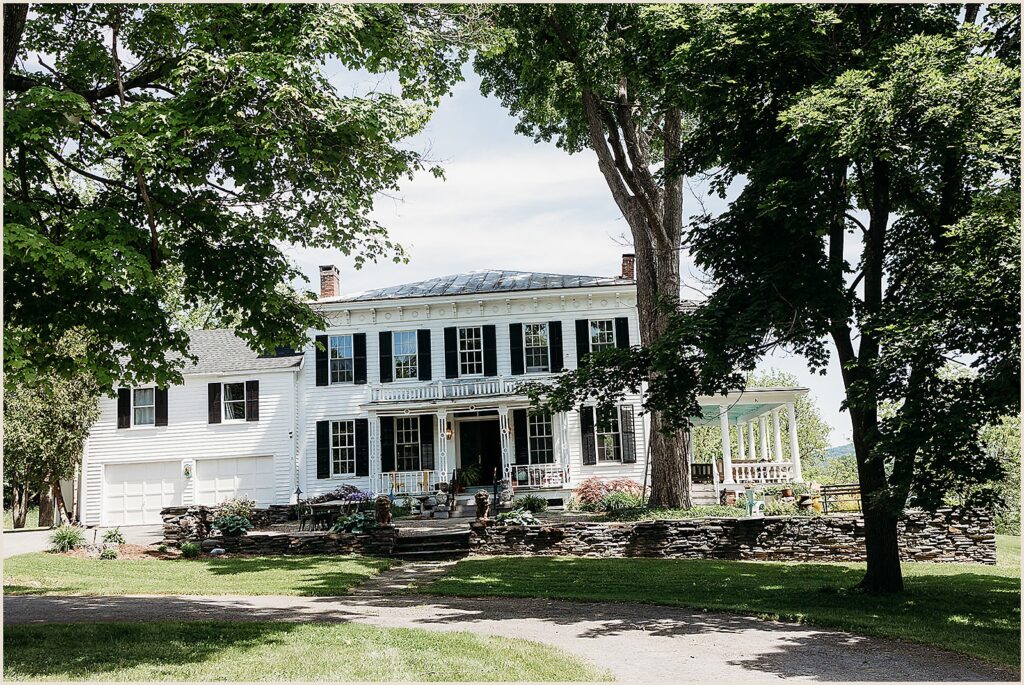 The sun shines on the farmhouse at The Maples Estate.