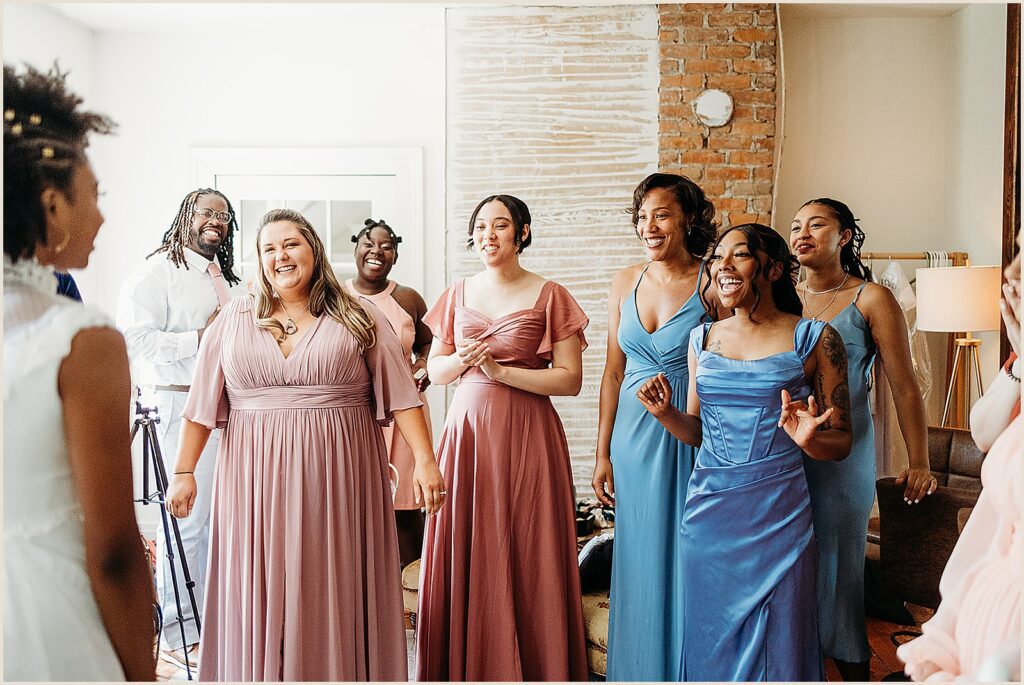 A bride has a first look with her bridesmaids.