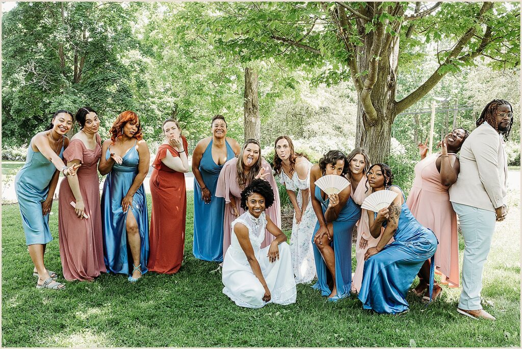 A bride and bridesmaids pose for a New York wedding photographer.