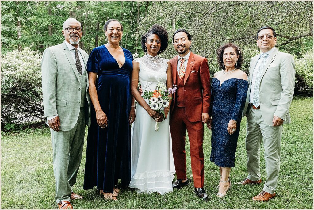 A bride and groom pose with their parents at an Upstate New York wedding venue.