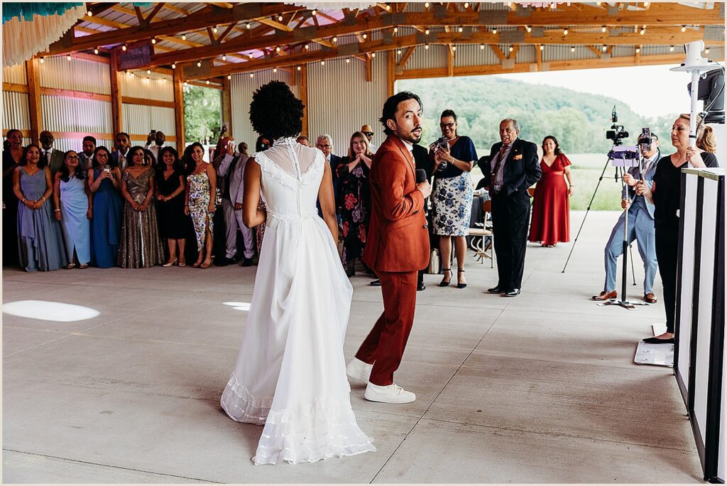 A bride and groom enter their reception.