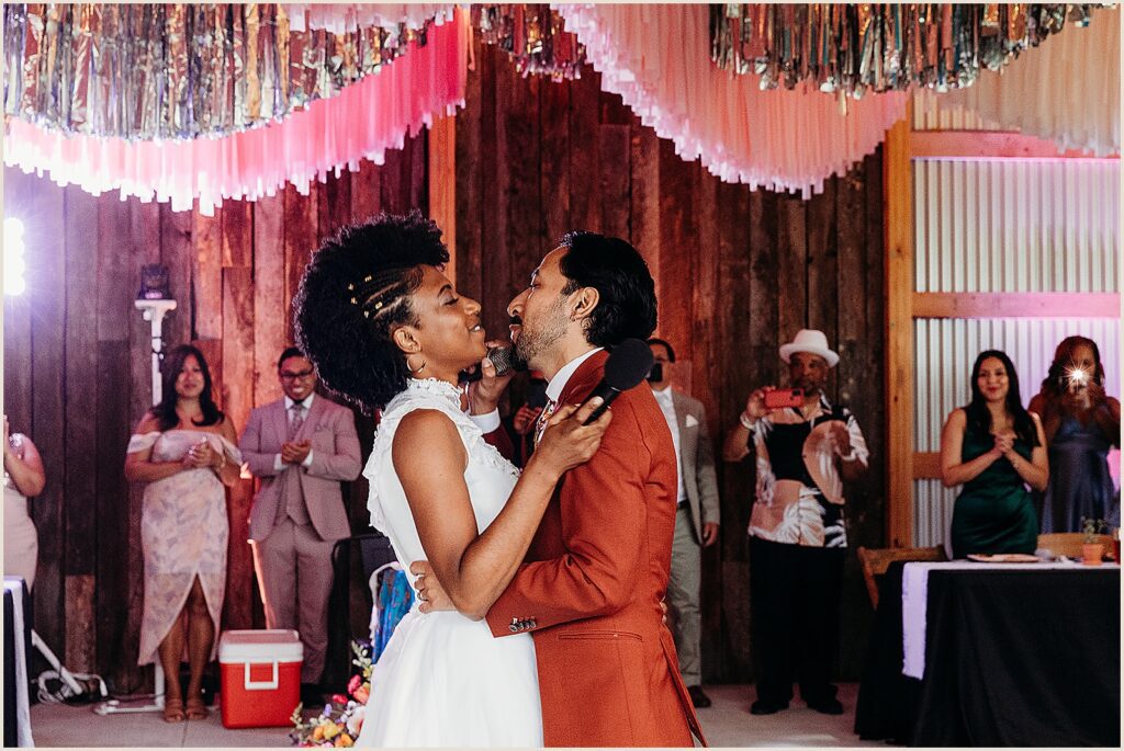 A bride and groom embrace during a reception at The Maples Estate.