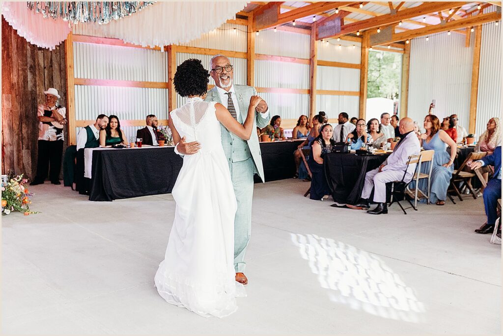 A bride dances with her father.