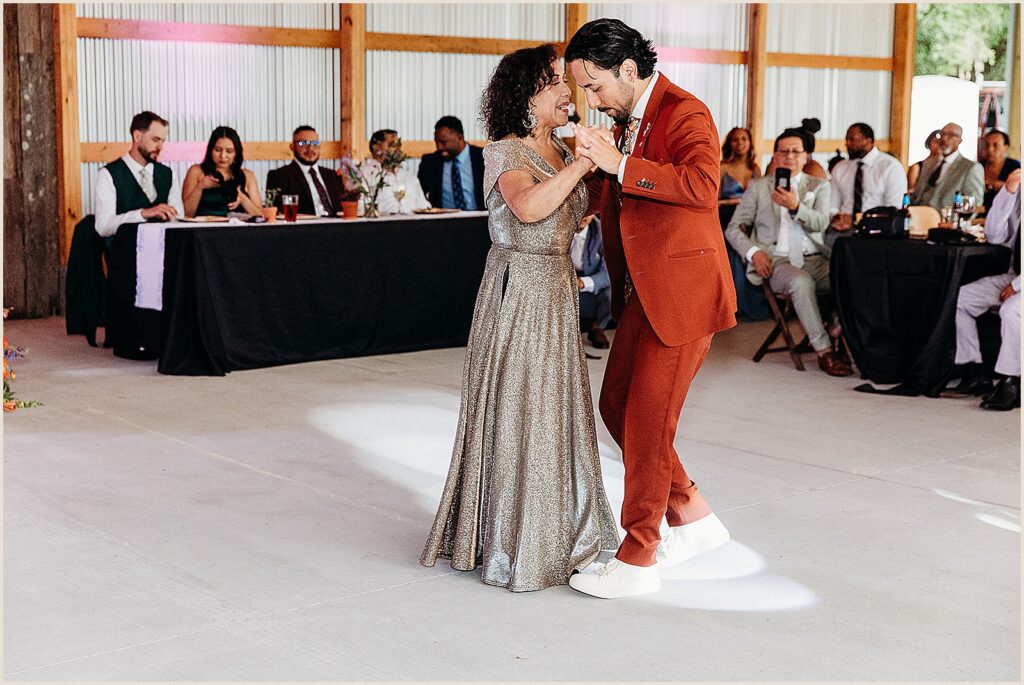 A groom dances with his mother.