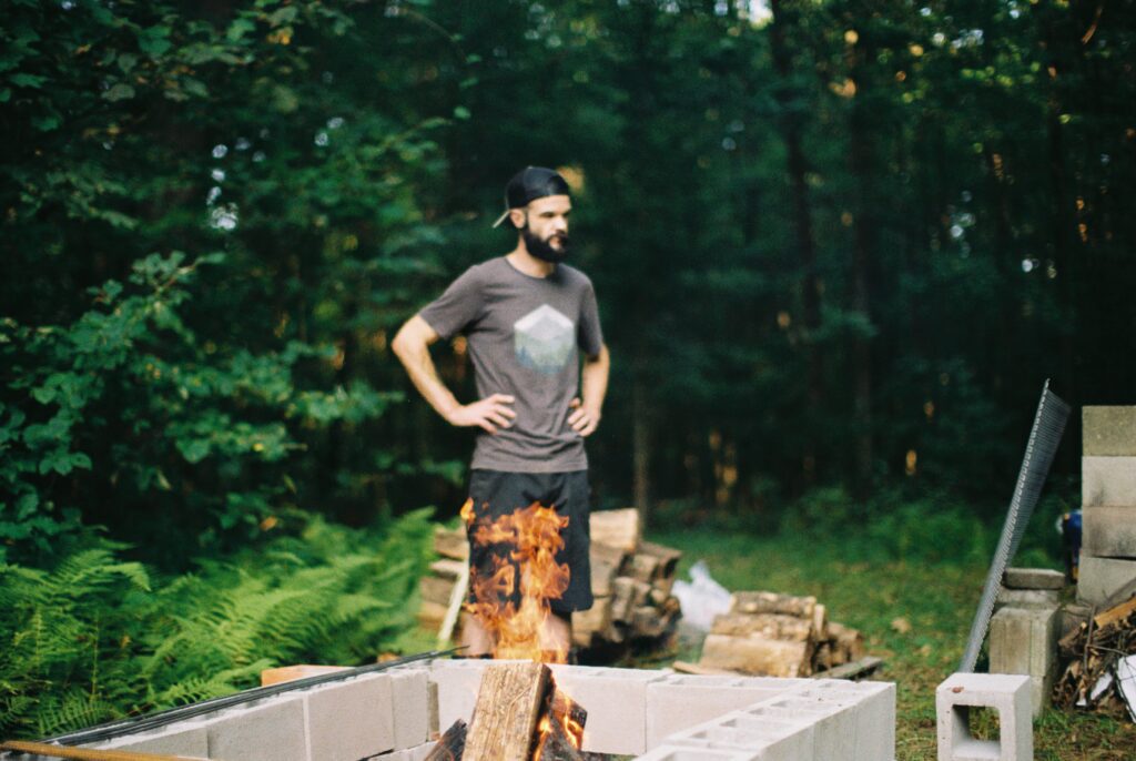 A man stands with his hands on his hips.