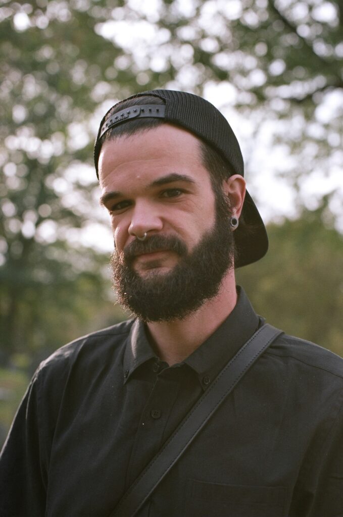 A man looks at a film photographer.