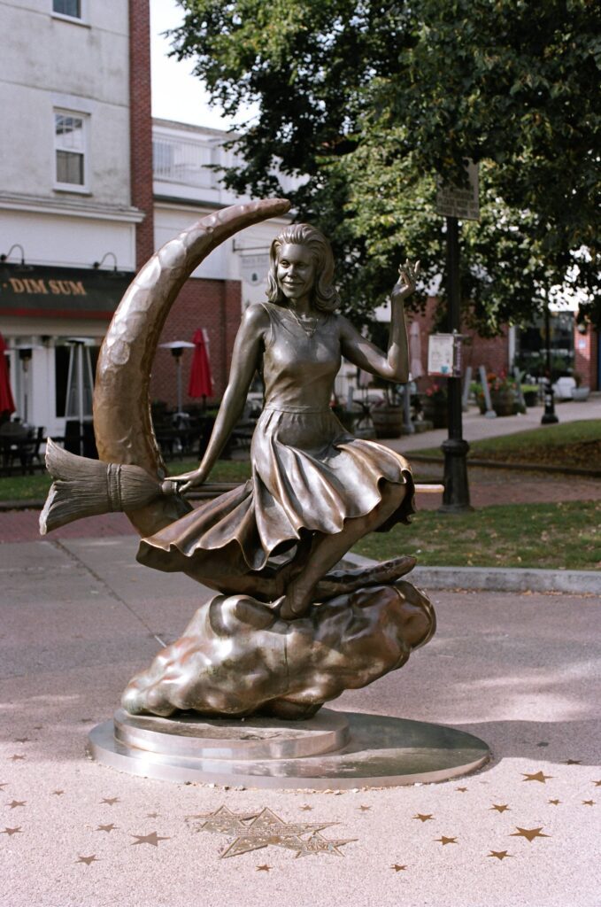 In downtown Salem, a statue of a witch stands in square.