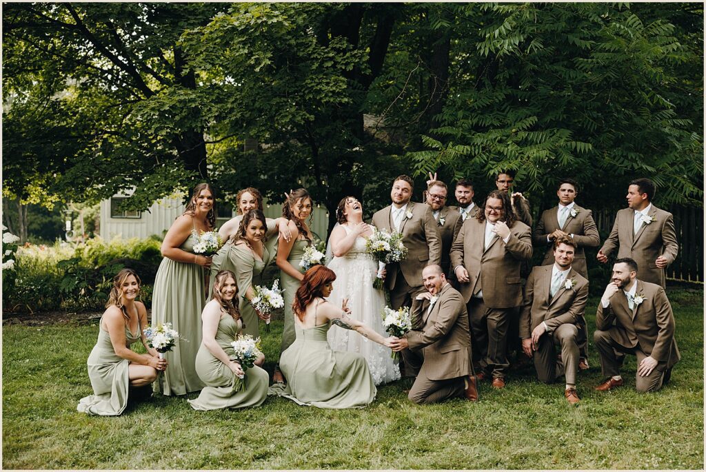 A bride and groom pose with their wedding party.