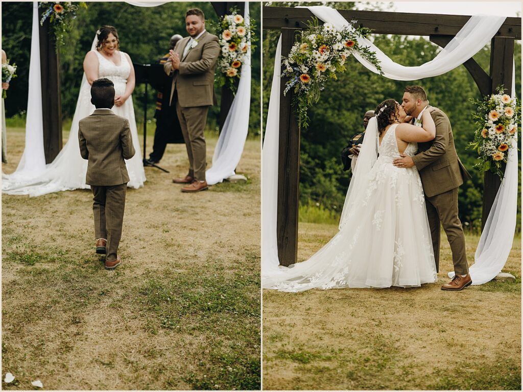 A bride and groom share their first kiss at the end of a summer wedding ceremony.