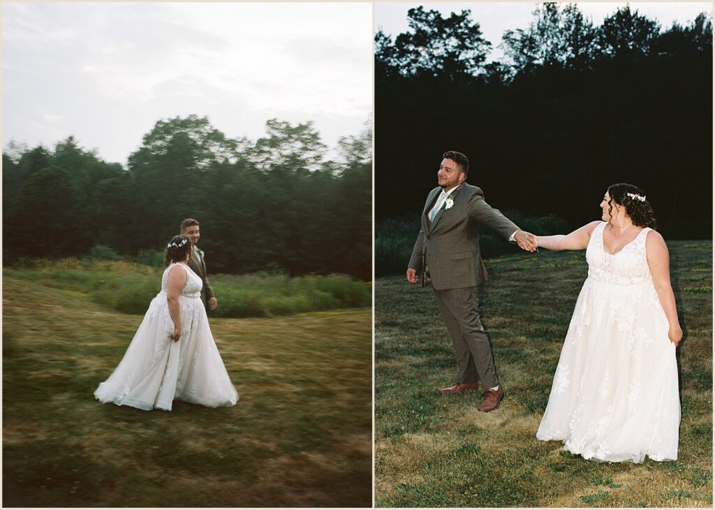 A bride and groom hold hands and walk through a meadow in a film wedding photo.