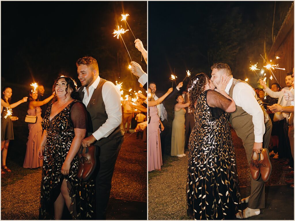 A bride and groom kiss during their sparkler exit.