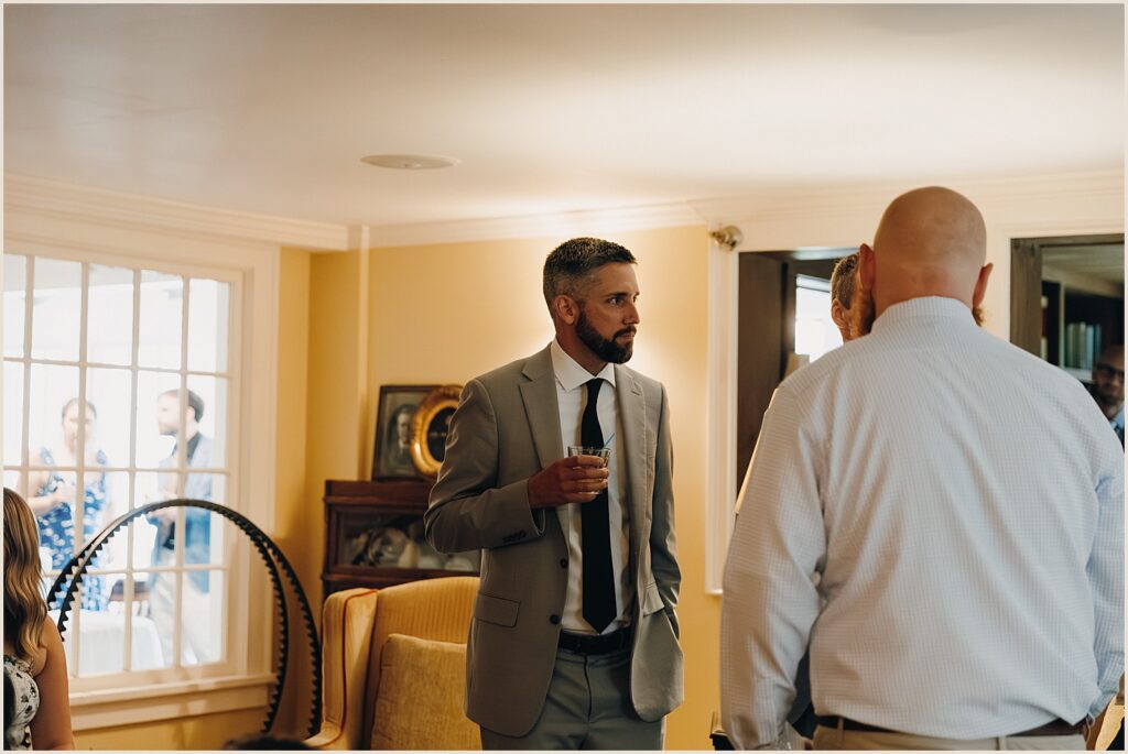 Wedding guests drink cocktails in a Vermont inn.