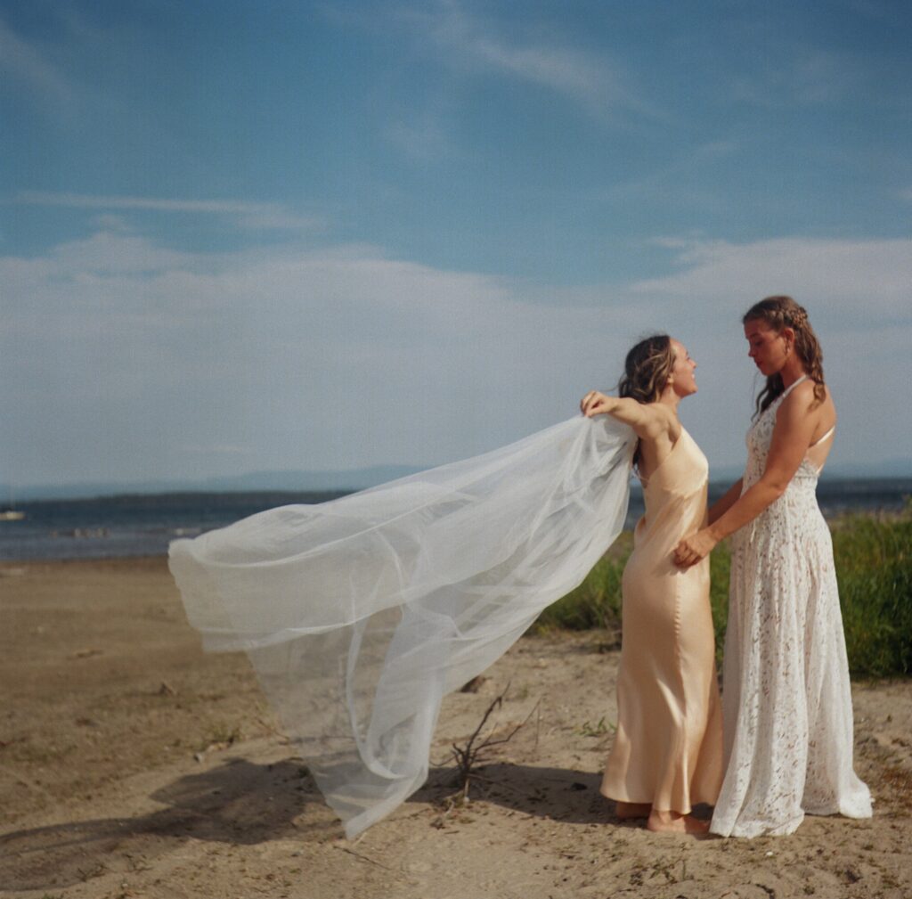 Bride wearing meaningful jewelry and a flowing veil as part of a symbolic, intentional wedding day.